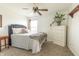 Bright bedroom with plush carpeting, a stylish bed, and a white dresser at 2096 Whitetail Ct, Avon, IN 46123