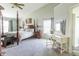 Elegant bedroom with a four-poster bed, vanity, and neutral decor at 2096 Whitetail Ct, Avon, IN 46123