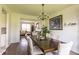 Elegant dining room with hardwood floors, a chandelier, and views into the living room at 2096 Whitetail Ct, Avon, IN 46123