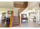 Spacious foyer with a wooden staircase and views into the dining and living areas at 2096 Whitetail Ct, Avon, IN 46123