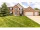 Charming brick two-story home with a well-manicured lawn and three-car garage at 2096 Whitetail Ct, Avon, IN 46123
