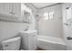 Cozy bathroom with a shower-tub combo and tiled walls at 2164 E Raymond St, Indianapolis, IN 46203