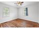 Comfortable bedroom with hardwood floors, two windows, and neutral decor at 2164 E Raymond St, Indianapolis, IN 46203