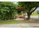 Wooden pergola over a stone tile pad beside the sidewalk and street at 2164 E Raymond St, Indianapolis, IN 46203