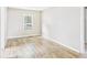 Spacious bedroom with hardwood floors, a bright window, and ample natural light at 2405 E 9Th St, Anderson, IN 46012