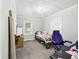 Well-lit bedroom featuring a cozy bed, window, and a comfortable gaming chair, perfect for work or play at 2405 E 9Th St, Anderson, IN 46012