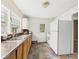 Efficient kitchen with ample counter space, white appliances, and vinyl tile flooring at 2405 E 9Th St, Anderson, IN 46012