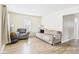 Bright living room featuring hardwood floors, neutral walls, and comfortable seating at 2405 E 9Th St, Anderson, IN 46012