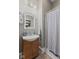 Cozy bathroom with gray walls, a decorative mirror, and a vanity with integrated sink at 245 S Washington St, Danville, IN 46122