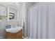 Cozy bathroom with gray walls, a decorative mirror, and a vanity with integrated sink at 245 S Washington St, Danville, IN 46122