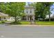 Charming two-story home boasts a quaint front porch and lush, mature trees at 245 S Washington St, Danville, IN 46122