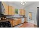 Charming kitchen with light wood cabinets, dark countertops, stainless steel appliances, and hardwood floors at 245 S Washington St, Danville, IN 46122