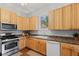 Bright kitchen with light wood cabinets, stainless steel appliances, and a window overlooking the backyard at 245 S Washington St, Danville, IN 46122