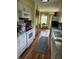Functional kitchen with white cabinetry, stainless steel appliances, and a well-lit window at 247 Meridian Ct, Pittsboro, IN 46167
