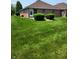 Landscaped backyard with lush green lawn and neatly trimmed shrubs, perfect for outdoor enjoyment at 247 Meridian Ct, Pittsboro, IN 46167