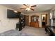 Bedroom features a large TV, dark dresser, desk area, and view to attached bathroom at 2782 Branigin Creek Blvd, Franklin, IN 46131
