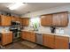 Well-lit kitchen with stainless steel appliances, wood cabinetry, and a window above sink at 2782 Branigin Creek Blvd, Franklin, IN 46131