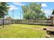 Fenced backyard features well-manicured grass and lush trees for privacy and shade at 31 S Hinman St, Columbus, IN 47201