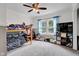 Cozy bedroom with carpet, a ceiling fan, and natural light, creating a comfortable and inviting space for relaxation at 31 S Hinman St, Columbus, IN 47201