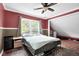Cozy bedroom showcasing a metal frame bed, large window, and neutral-toned walls with an area rug at 31 S Hinman St, Columbus, IN 47201