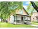 A partial side view of a home showing the covered porch and decorative color scheme of the exterior at 31 S Hinman St, Columbus, IN 47201