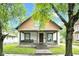 Charming two-story home with a welcoming front porch and inviting curb appeal with mature trees at 31 S Hinman St, Columbus, IN 47201