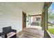 Inviting front porch with a classic porch swing, chair, and charming details at 31 S Hinman St, Columbus, IN 47201
