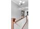Upstairs hallway, with white railing, shows an inviting landing space with access to bedrooms and bathrooms at 31 S Hinman St, Columbus, IN 47201