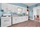 Well-lit kitchen featuring white cabinets, gas range, and modern sink fixture, offering practicality and style at 31 S Hinman St, Columbus, IN 47201