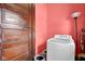 Convenient laundry room with modern appliances, wood door, and ample space for storage, making chores a breeze at 31 S Hinman St, Columbus, IN 47201