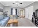 Inviting living room with cozy seating, plush carpeting, and access to the front porch at 31 S Hinman St, Columbus, IN 47201
