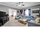 Cozy living room featuring comfortable seating, soft carpet, and a ceiling fan at 31 S Hinman St, Columbus, IN 47201
