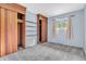 Spacious bedroom featuring ample closet space, modern carpeting, and natural light from a window at 3201 Chamberlin Dr, Indianapolis, IN 46227