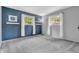 Stylish bedroom featuring a blue accent wall, two windows, and contemporary decor at 3201 Chamberlin Dr, Indianapolis, IN 46227