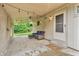 Inviting covered patio featuring a comfortable wicker sofa set and string lights for ambiance at 3201 Chamberlin Dr, Indianapolis, IN 46227