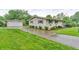 Exterior view of home and detached garage with a concrete driveway at 3201 Chamberlin Dr, Indianapolis, IN 46227