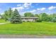 A well-kept lawn surrounds the charming home, showcasing its curb appeal at 3201 Chamberlin Dr, Indianapolis, IN 46227