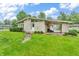 Charming exterior view of the home with a well-manicured lawn and a covered patio area at 3201 Chamberlin Dr, Indianapolis, IN 46227