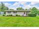 Charming ranch home featuring a well-manicured lawn and tidy landscaping at 3201 Chamberlin Dr, Indianapolis, IN 46227