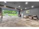 Open garage with an open door offering an outside view of the driveway and front yard at 3201 Chamberlin Dr, Indianapolis, IN 46227