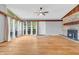 Bright living room with hardwood floors, stone fireplace, and large windows at 3201 Chamberlin Dr, Indianapolis, IN 46227