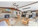 Staged open concept with hardwood floors and a stone fireplace in the living area at 3201 Chamberlin Dr, Indianapolis, IN 46227