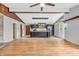 Open-concept living area with wood beams, fireplace, and modern kitchen at 3201 Chamberlin Dr, Indianapolis, IN 46227