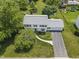 Aerial view of the home with a well-manicured front yard, mature trees, and a driveway leading to an attached garage at 321 4Th E Ct, Carmel, IN 46033