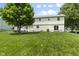 Expansive backyard featuring a lush lawn, mature trees, and a patio area perfect for outdoor entertaining at 321 4Th E Ct, Carmel, IN 46033