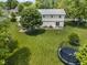 Enjoy the expansive backyard with a trampoline and well-manicured lawn, perfect for outdoor activities at 321 4Th E Ct, Carmel, IN 46033
