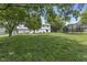 Enjoy outdoor living with a spacious lawn, mature trees, and recreational space in this backyard at 321 4Th E Ct, Carmel, IN 46033