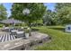 Relax on the concrete backyard patio complete with furniture and lush surrounding landscape at 321 4Th E Ct, Carmel, IN 46033
