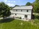 This backyard has a patio area, lush green lawn, and mature trees offering shade at 321 4Th E Ct, Carmel, IN 46033