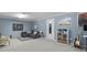 Finished basement with gray sectional, decorative rug, shelving and neutral walls, perfect for Gathering time at 321 4Th E Ct, Carmel, IN 46033